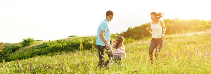 Family running in a field